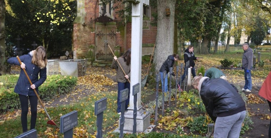 Jugendliche bei einem Pflegeeinsatz auf der Kriegsgräberstätte in Wittenburg am 01. November 2025